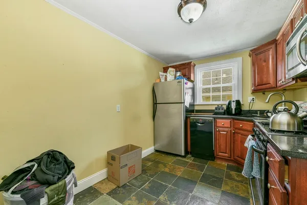 a kitchen with stainless steel appliances granite countertop a refrigerator stove a sink dishwasher and microwave oven