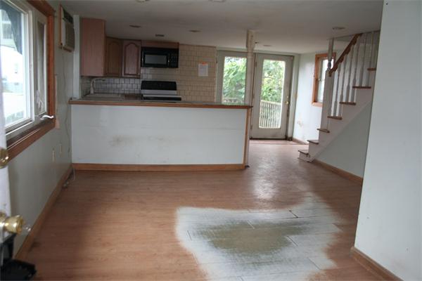 394 Hartwell Street Fall River, MA 02721 - Photo 3 of 7 a view of a kitchen with wooden floor and a window
