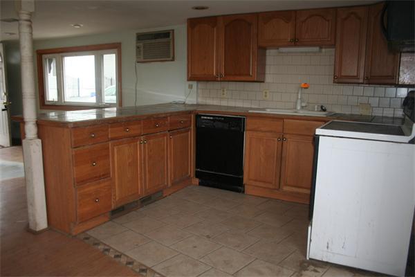 394 Hartwell Street Fall River, MA 02721 - Photo 4 of 7 a kitchen with stainless steel appliances granite countertop a sink stove and cabinets