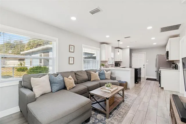 a view of an empty room with cabinet and a window