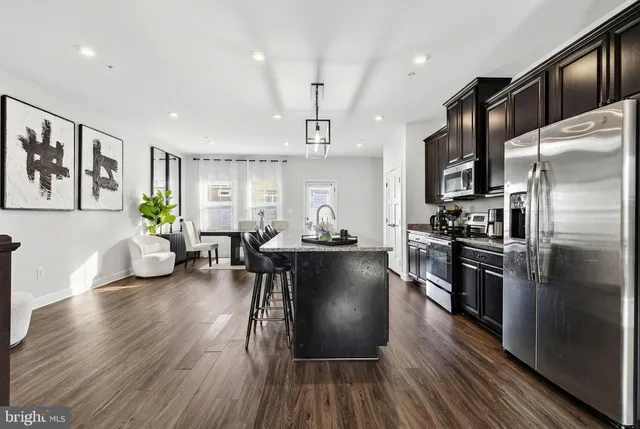 a bathroom with a sink vanity granite toilet and a mirror