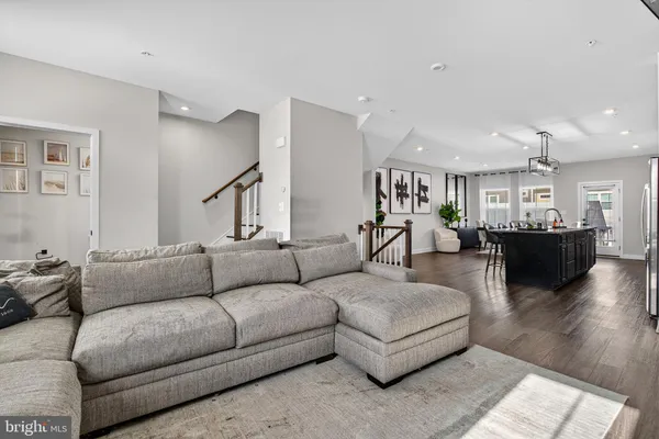a living room with furniture and kitchen view