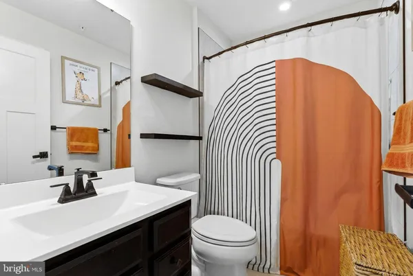 a bathroom with a sink toilet and mirror