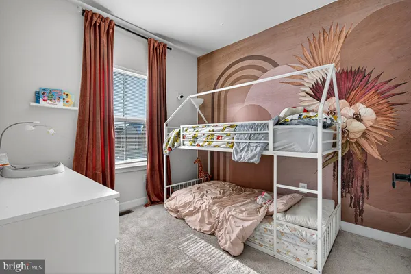 a bedroom with a bed and a mirror