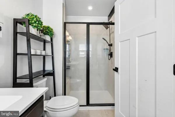 a bathroom with a shower a toilet and a sink