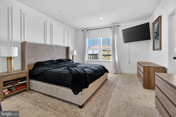 a bedroom with a bed and a flat screen television