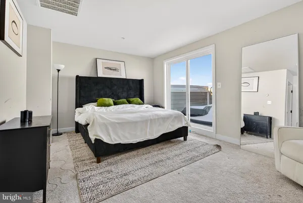 a bedroom with a bed and glass window