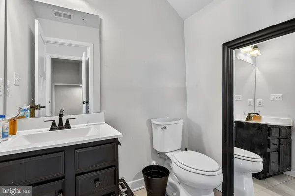 a bathroom with a toilet sink and mirror