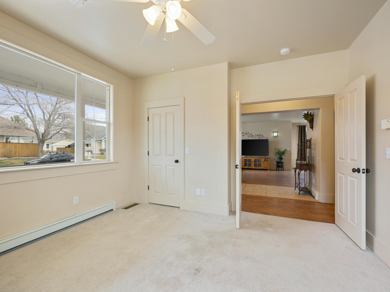 1110 Buttercup Lane Fruita, CO 81521 - Photo 15 of 27 wooden floor in an empty room with a window