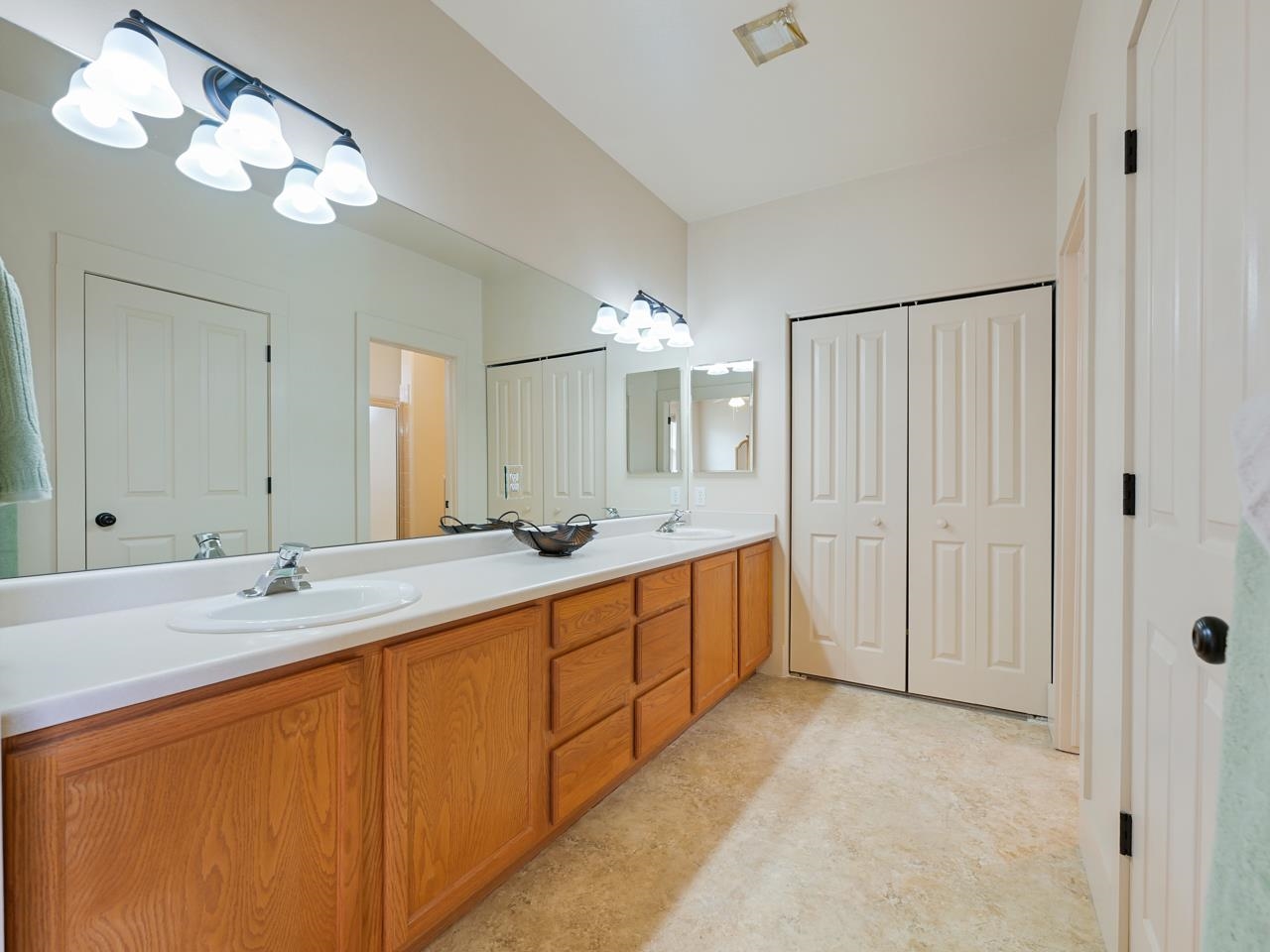 1110 Buttercup Lane Fruita, CO 81521 - Photo 19 of 27 a spacious bathroom with a double vanity sink and a mirror