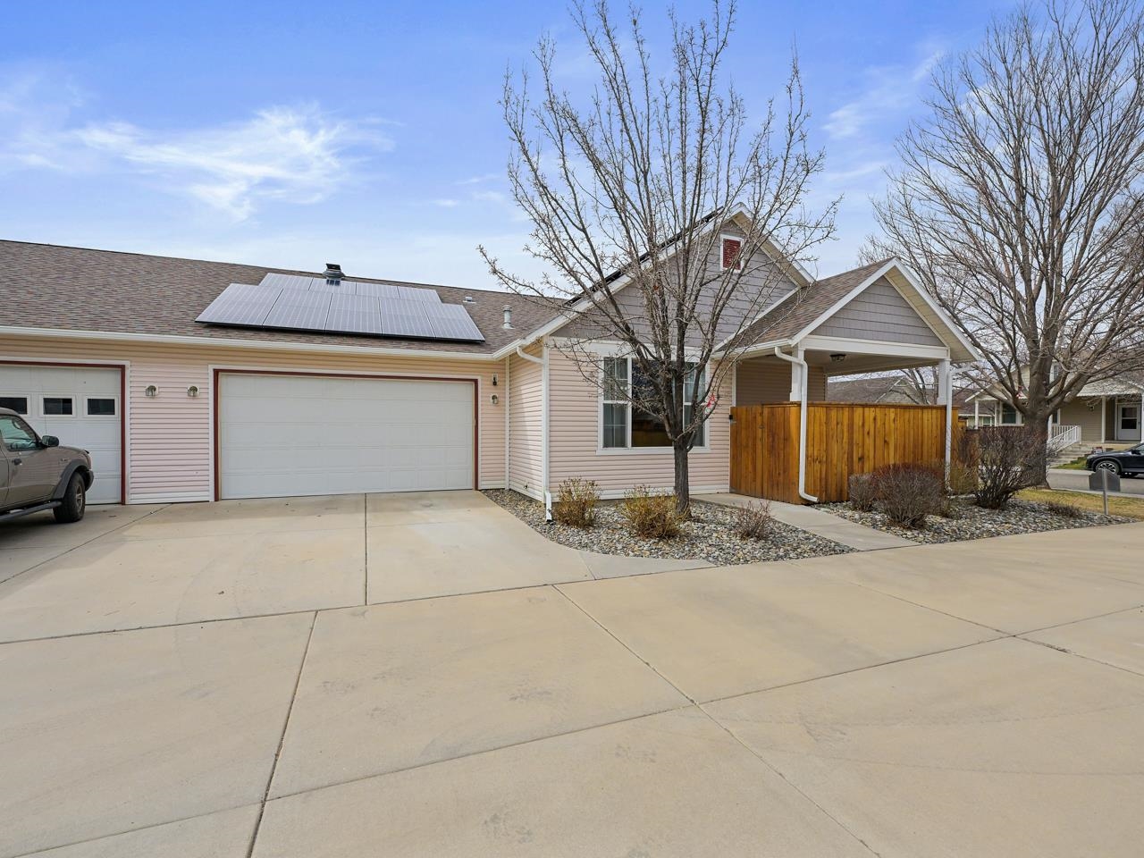 1110 Buttercup Lane Fruita, CO 81521 - Photo 23 of 27 a front view of a house with a yard and garage