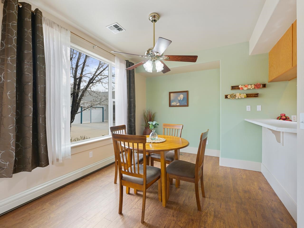 1110 Buttercup Lane Fruita, CO 81521 - Photo 3 of 27 a dining room with furniture a chandelier and wooden floor