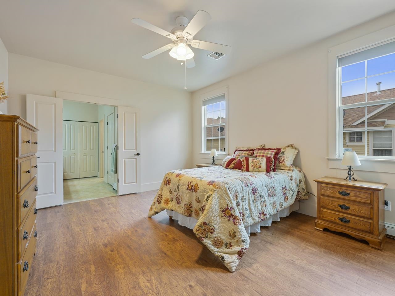 1110 Buttercup Lane Fruita, CO 81521 - Photo 4 of 27 a spacious bedroom with a bed and a chandelier