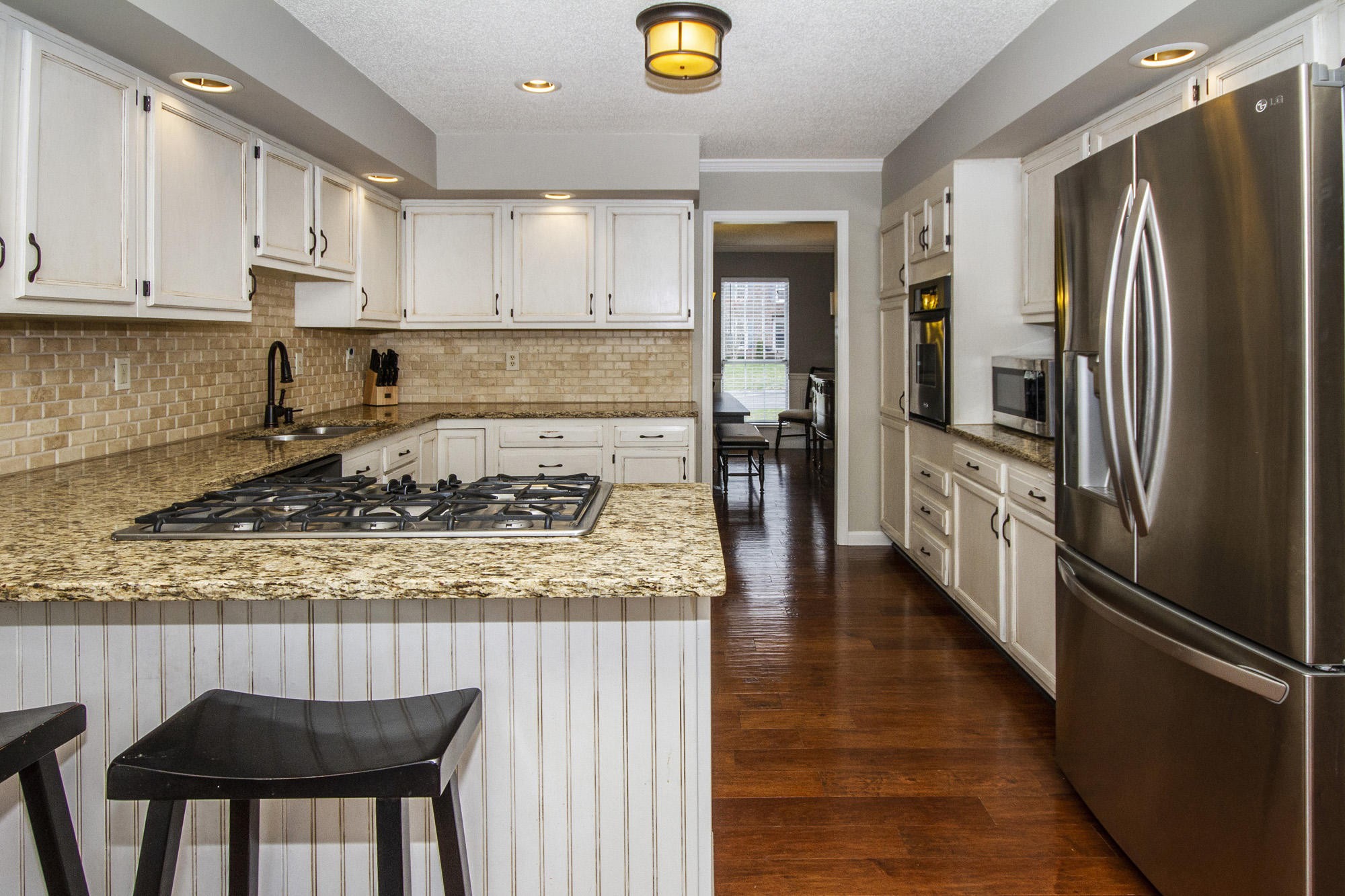 229 Long Bow Road Knoxville, TN 37934 - Photo 13 of 38 a kitchen with stainless steel appliances granite countertop a refrigerator a stove and a wooden floors