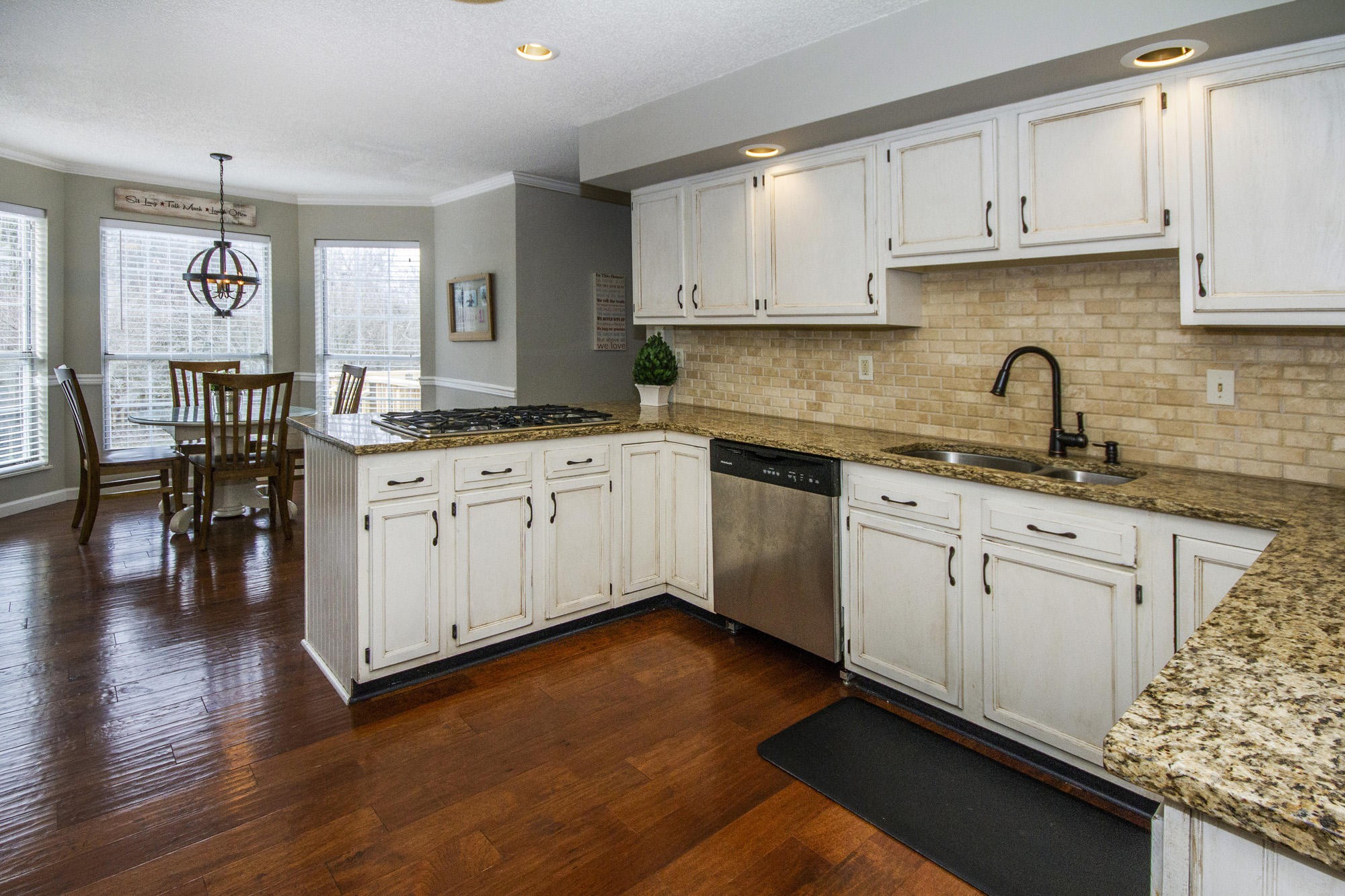 229 Long Bow Road Knoxville, TN 37934 - Photo 4 of 38 a kitchen with granite countertop a sink cabinets and wooden floor