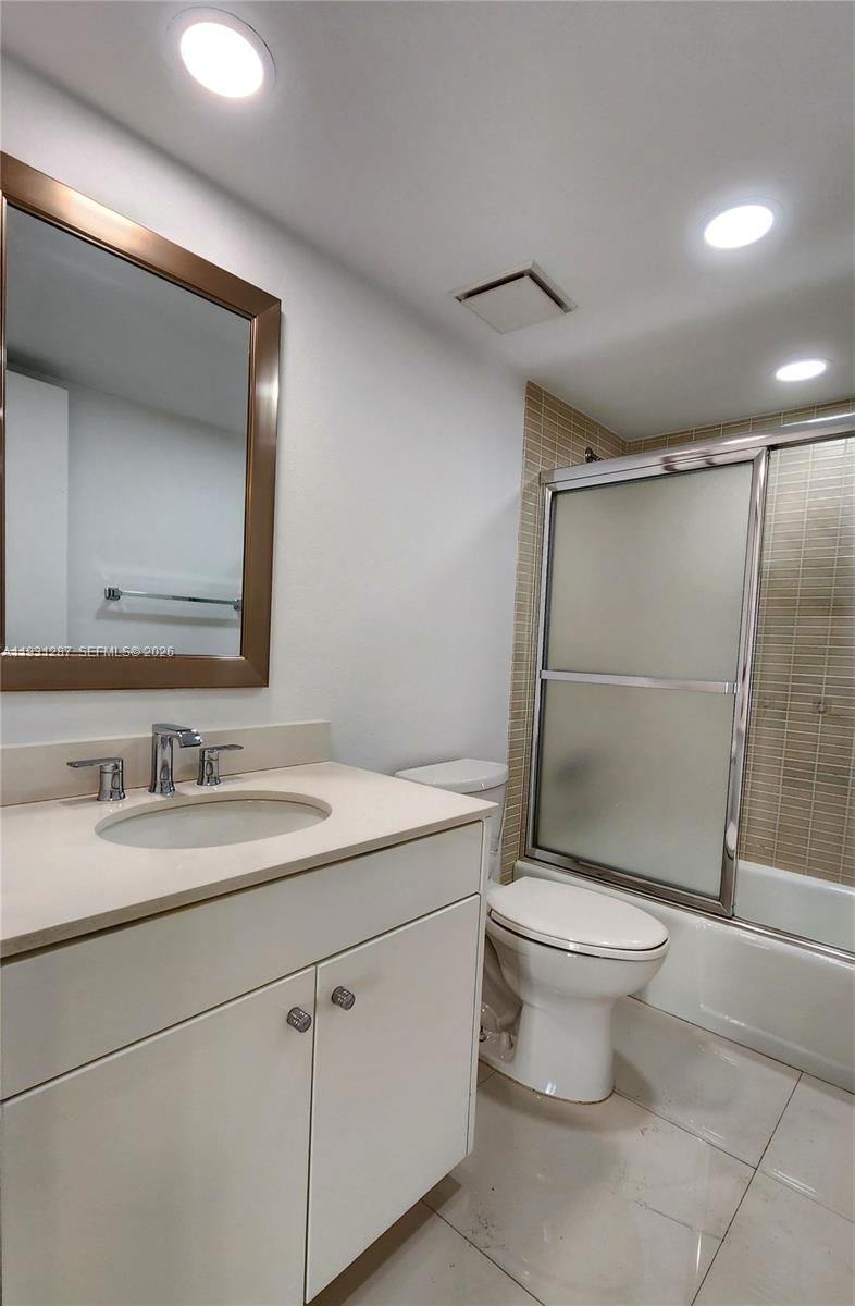 520 Brickell Key Drive, Unit A802 Miami, FL 33131 - Photo 11 of 13 a bathroom with a toilet sink and a mirror