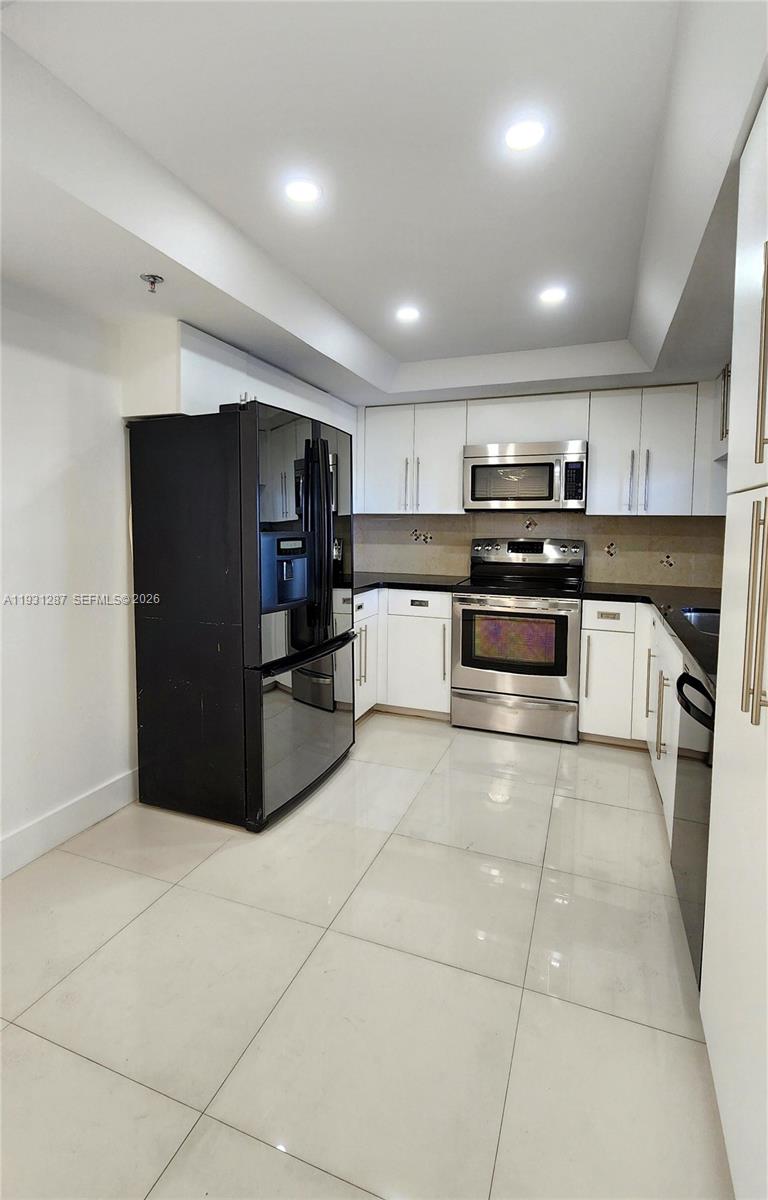 520 Brickell Key Drive, Unit A802 Miami, FL 33131 - Photo 6 of 13 a kitchen with stainless steel appliances granite countertop a refrigerator and a stove top oven