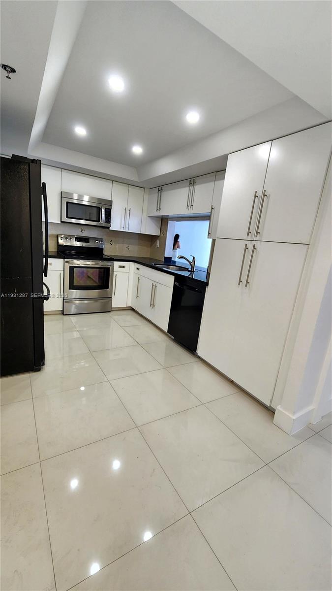 520 Brickell Key Drive, Unit A802 Miami, FL 33131 - Photo 7 of 13 a kitchen with stainless steel appliances a refrigerator and a stove top oven