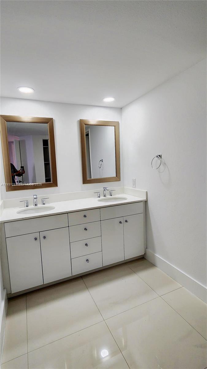 520 Brickell Key Drive, Unit A802 Miami, FL 33131 - Photo 9 of 13 a bathroom with a double vanity sink and mirror