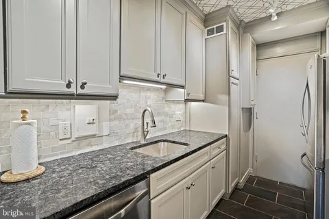 a kitchen with a sink and cabinets