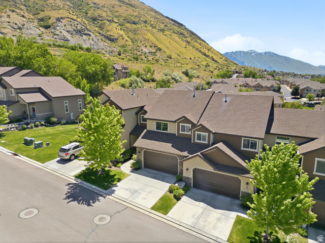 1614 Aspen Loop Provo, UT 84606 - Photo 3 of 47 Contemporary townhome-style residences featuring attached garages, paved driveways, and surrounding green spaces