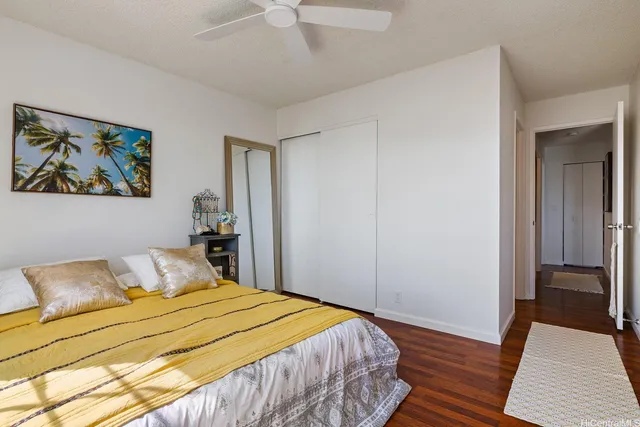 a bedroom with a bed and a painting on the wall
