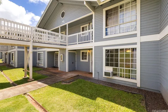 a view of a house with backyard and porch