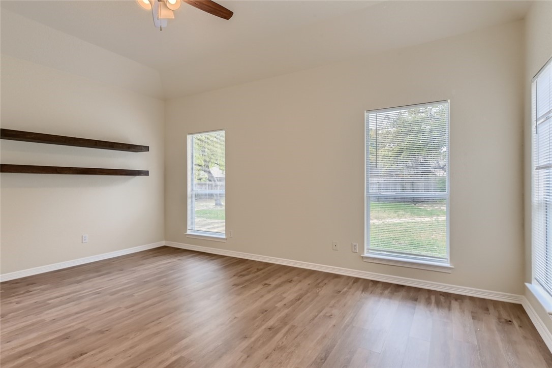 511 Susana Drive Georgetown, TX 78628 - Photo 17 of 31 Spacious primary bedroom featuring vinyal plank flooring and ceiling fan