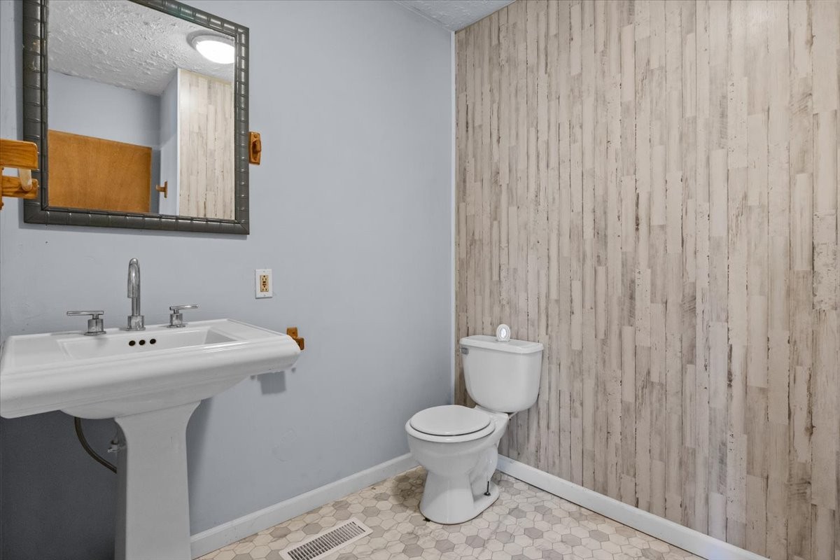 3316 Toms Creek Road Linden, TN 37096 - Photo 26 of 44 a bathroom with a toilet a sink and mirror