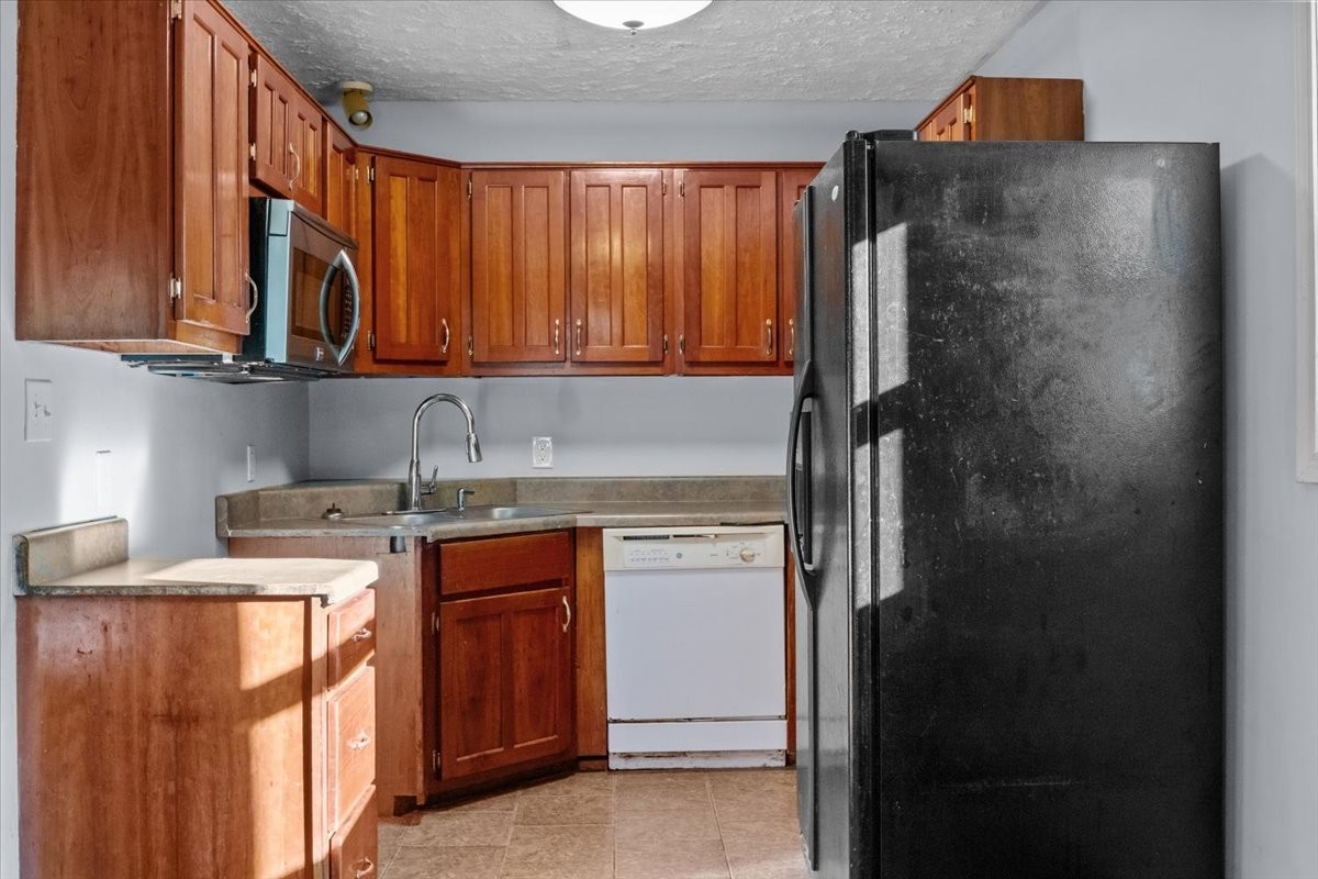 3316 Toms Creek Road Linden, TN 37096 - Photo 42 of 44 a kitchen with stainless steel appliances granite countertop a refrigerator and a stove