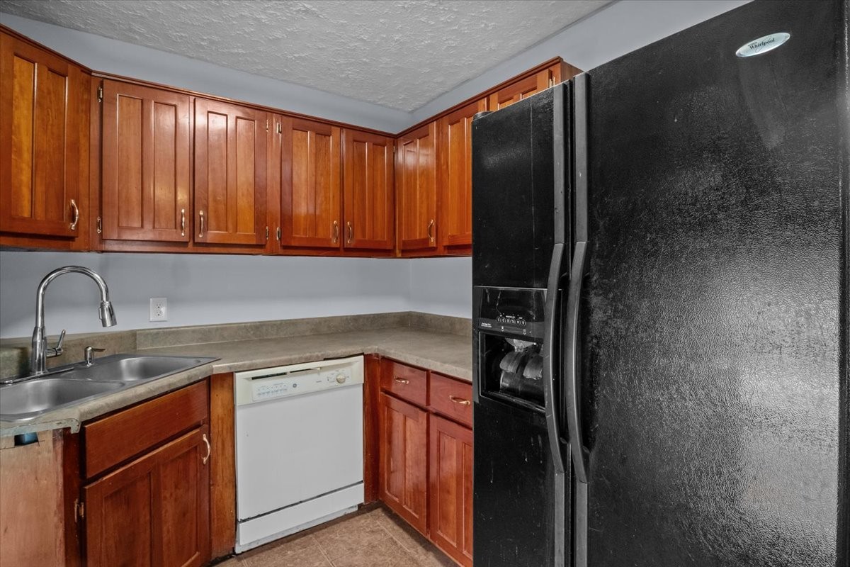 3316 Toms Creek Road Linden, TN 37096 - Photo 44 of 44 a kitchen with stainless steel appliances granite countertop a refrigerator and a sink