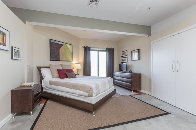 a bedroom with a bed and a couch