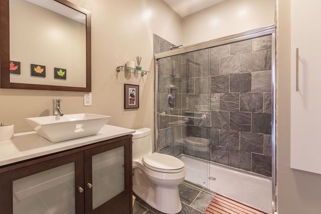 a bathroom with a sink toilet a mirror and shower