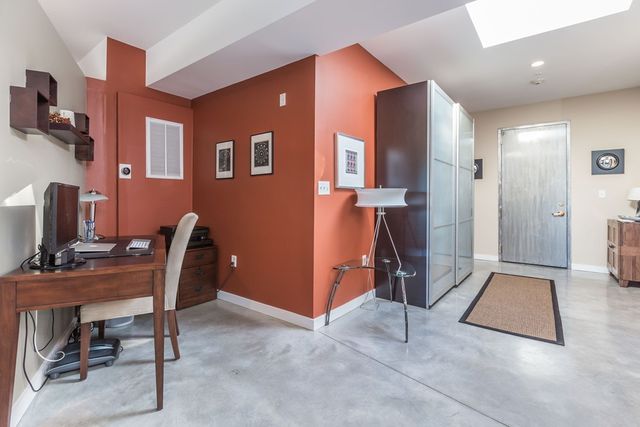 a workspace with furniture and a gym machine