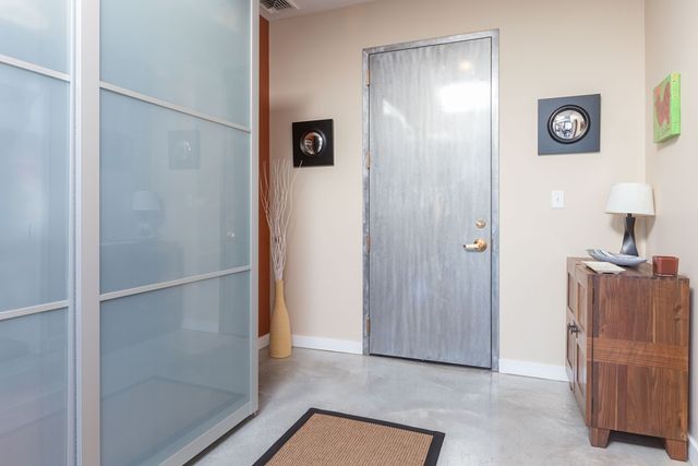 a view of a hallway to rooms and wooden floor