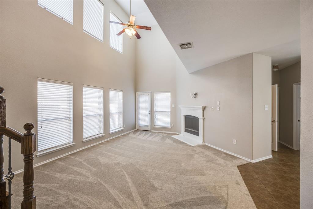 2228 Canyon Point McKinney, TX 75071 - Photo 15 of 40 a view of empty room with fireplace and windows