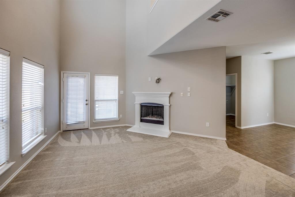 2228 Canyon Point McKinney, TX 75071 - Photo 17 of 40 a view of an empty room with a fireplace and a window