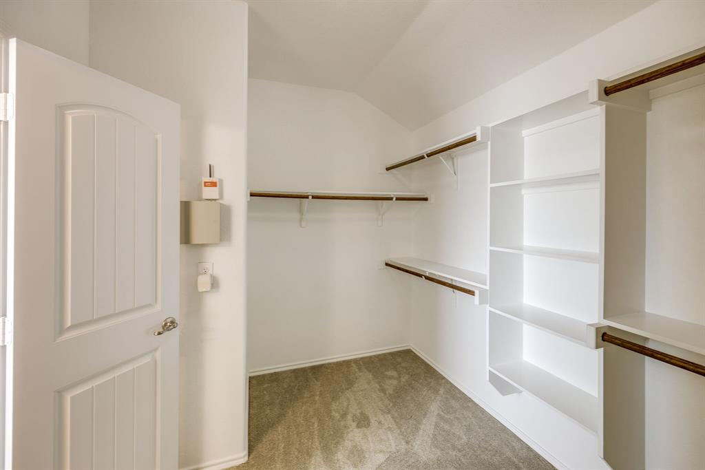 2228 Canyon Point McKinney, TX 75071 - Photo 36 of 40 a view of walk in closet with empty racks