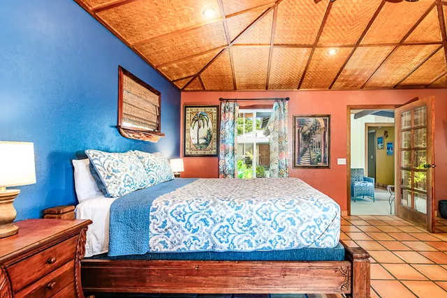 a bedroom with a bed and a television