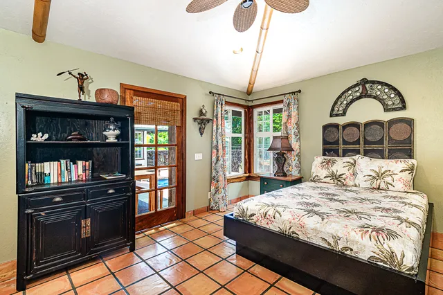 a living room with patio furniture and a large window