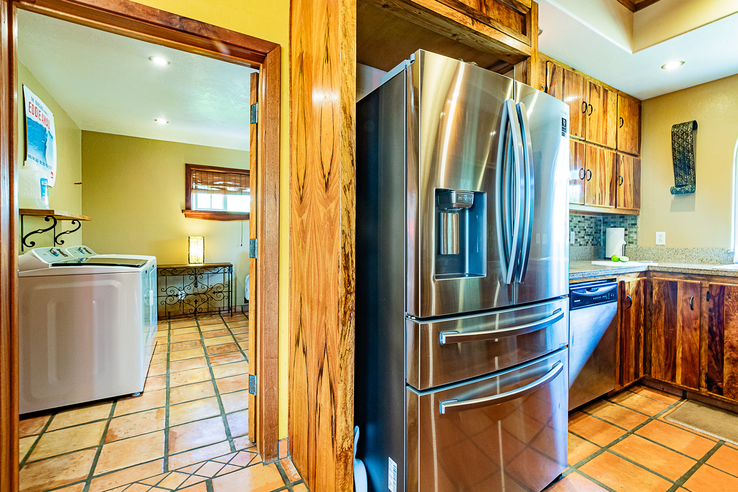 15-869 Lemiwai Road Keaau, HI 96749 - Photo 25 of 30 a kitchen with stainless steel appliances granite countertop a refrigerator and a stove