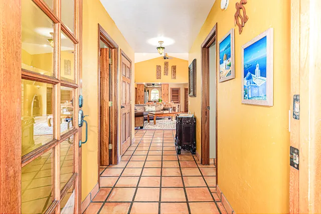 a living room with furniture a flat screen tv and a floor to ceiling window