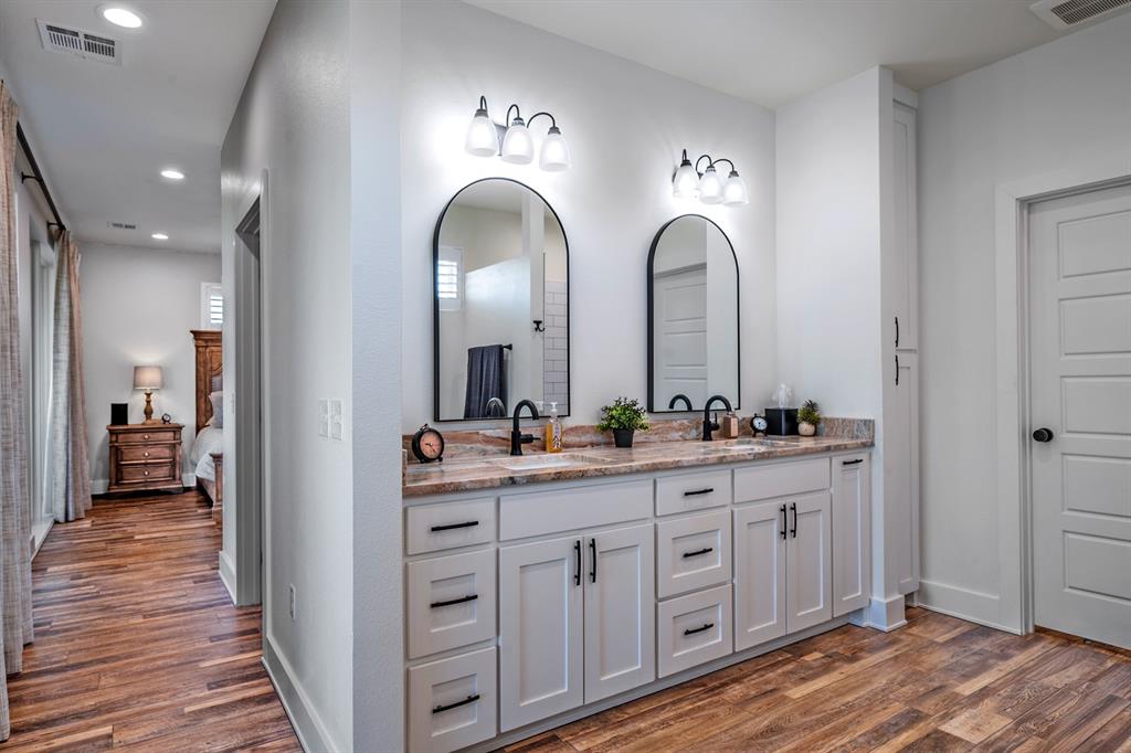 4509 Peach Tree Lane Kingston, OK 73439 - Photo 22 of 39 a en suite bathroom with a granite countertop sink and a mirror