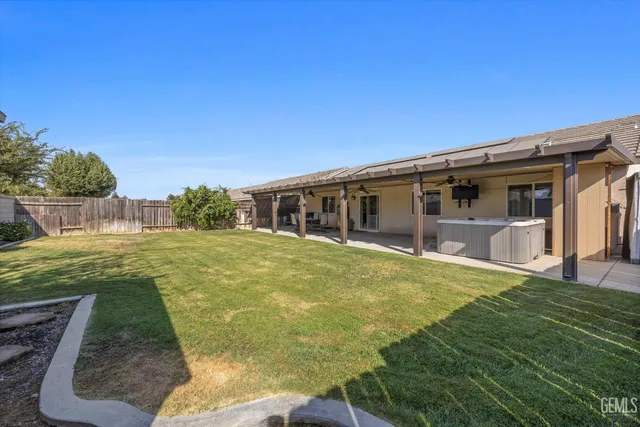 a view of an house with backyard space and balcony