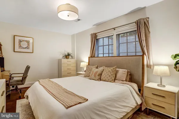 a bedroom with a bed and a window