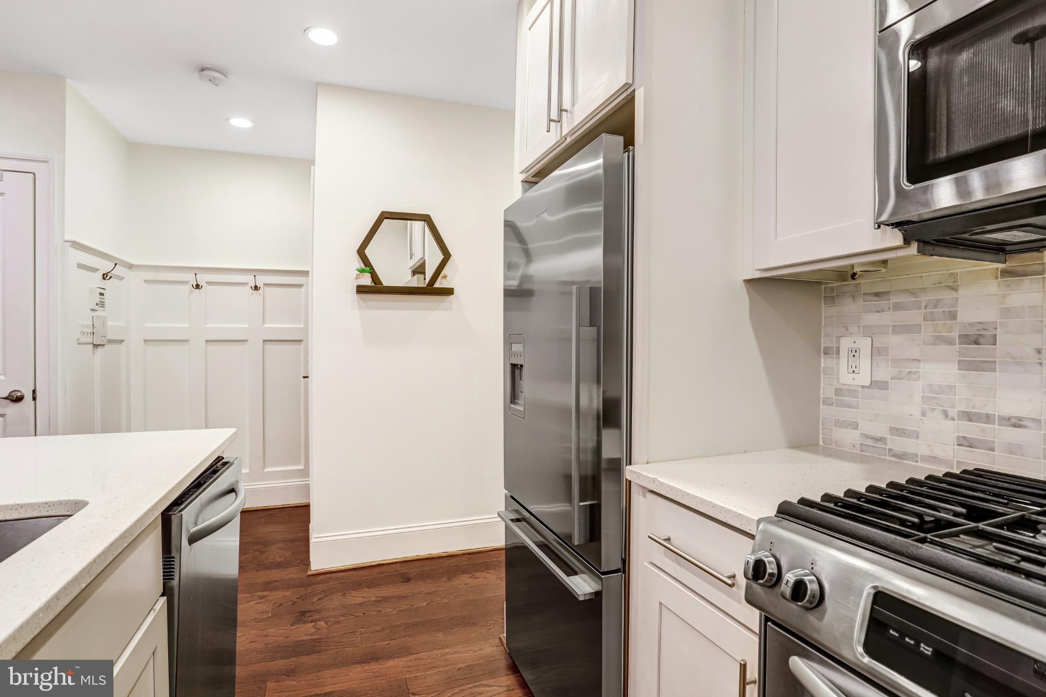3937 Davis Place Northwest, Unit 1 Washington, DC 20007 - Photo 10 of 22 a kitchen with granite countertop a stove and a refrigerator