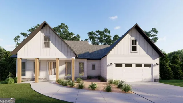 a front view of a house with a yard and potted plants