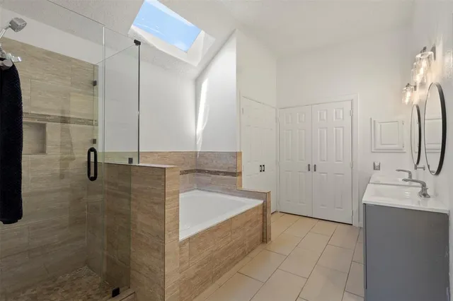 a bathroom with a tub sink and mirror