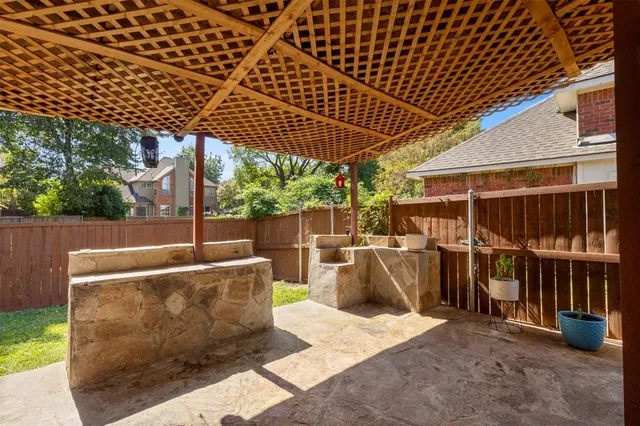 a view of a patio with table and chairs
