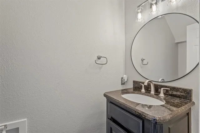 a view of a room with wooden floor chandelier and a window